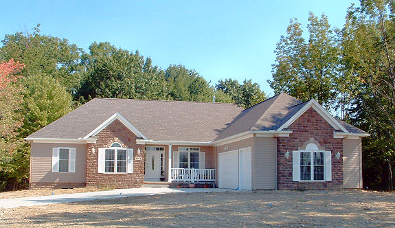 9' ceilings. Parlor/den with half-round window. Vaulted/cathedral ceiling in the foyer, great room, and kitchen. Gas or wood-burning fireplace. Formal dining room with high tray ceiling. Kitchen with attached breakfast room. Large master bedroom and bath with walk-in shower. Mud room and utility room. Covered front porch. 3-car side-entry garage.