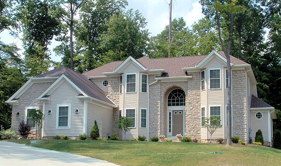 1st floor master bedroom with 9' trayed ceiling. Optional master bedroom fireplace. Cathedral ceiling in great room with optional skylights. 2 story foyer. Formal dining room or parlor with trayed ceiling. 1st floor sunroom/den. Partial stone or brick front. Arched covered porch. 1st floor laundry. 2-car side-entry garage.