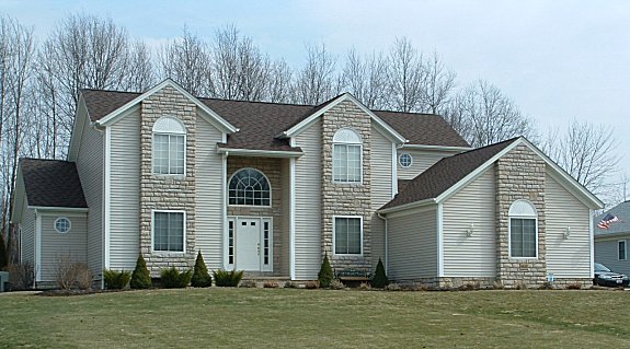 Large 1st floor master bedroom with 9' trayed ceiling and two walk-in closets. Cathedral/sloped ceiling in great room. 2 story foyer with bridge above. Formal dining room or parlor with tray ceiling. Large kitchen and dinette with lots of windows. 1st floor laundry. Covered porch. 2-car garage.