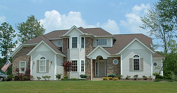 9 ft. ceilings on 1st floor. 1st floor great room/den and master bedroom have 10 ft. trayed ceilings.  Cathedral ceiling in great room with optional skylights. 2 story foyer. Formal dining room or parlor with trayed ceiling. Sun room with cathedral ceiling. Partial stone front. Arched covered porch. 1st floor laundry. 2-car side entry garage.